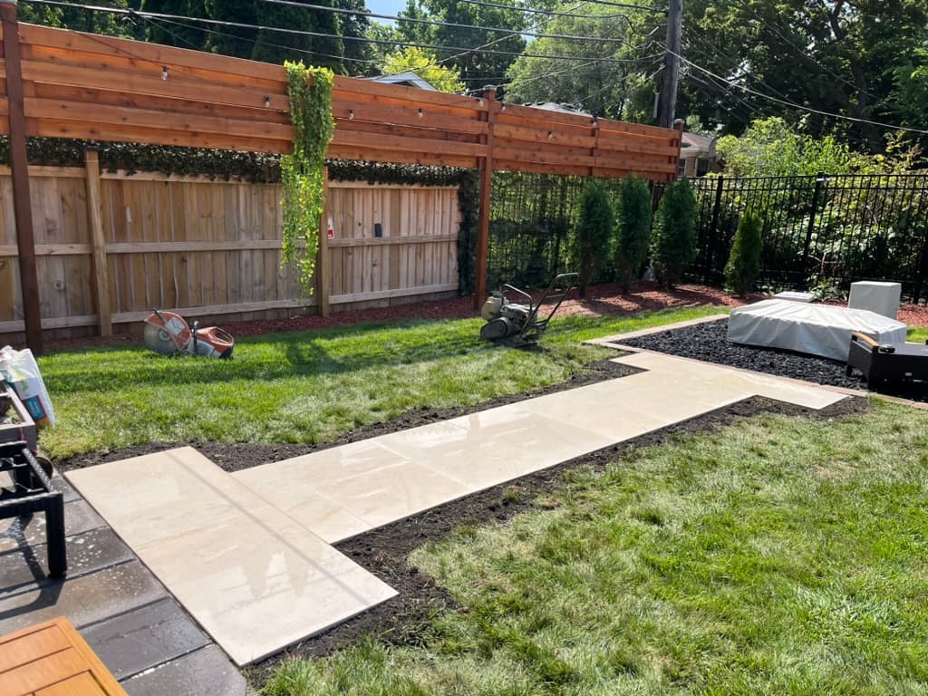 Large format paver installation creating generous outdoor living space