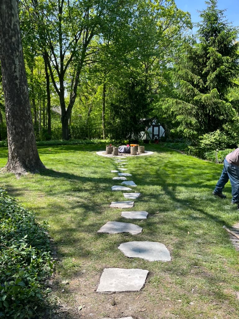 Natural stepping stone path leading to circular fire pit area