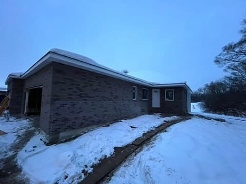 Completed brick work on ranch home photographed in winter snow